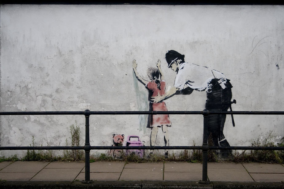 Policeman Searching Girl – Glastonbury Iconic Works by Banksy 